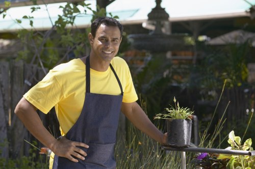 Gardener in St Giles working safely with protective gear