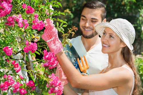 Professional gardener using PPE during garden maintenance
